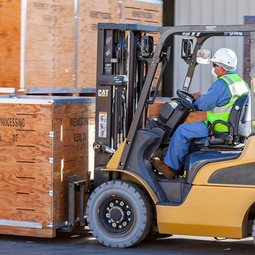 Forklift carrying a wood box