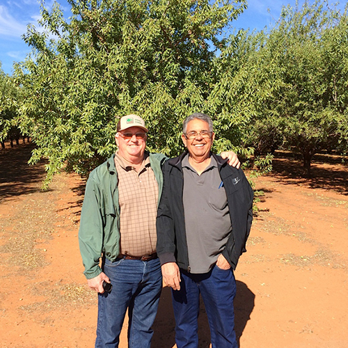 Mike Koehnen and Jim Paiva standing in an orchard