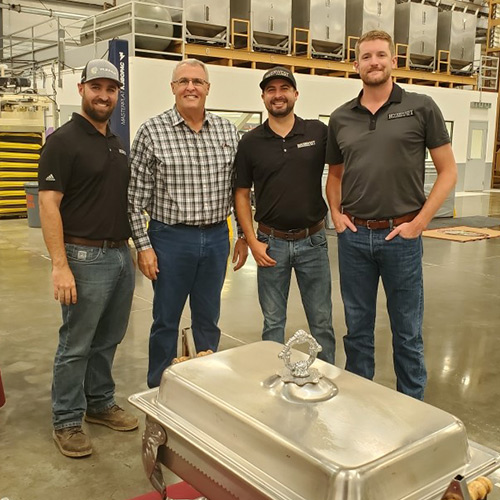 Four men standing inside the facility
